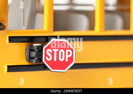 Yellow school bus, focus on stop sign. Transport for students Stock Photo