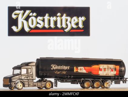 In this photo illustration, a model of a beer truck with an inscription Kostritzer on the background of the company logo on the monitor screen.  Kostr Stock Photo