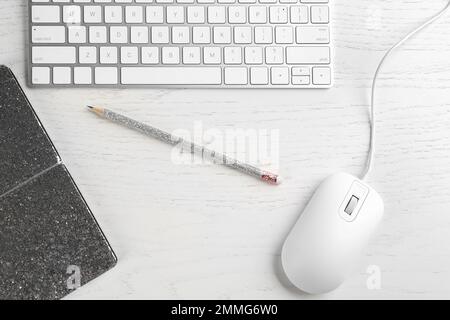 Flat lay composition with mouse and keyboard on white wooden table Stock Photo