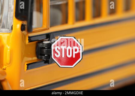 Yellow school bus, focus on stop sign. Transport for students Stock Photo