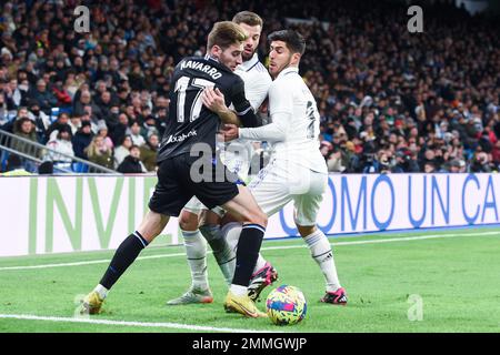 Madrid. 29th Jan, 2023. Nacho (C) and Marco Asensio (R) of Real Madrid vies with Robert Navarro of Real Sociedad during a Spanish La Liga football match between Real Madrid and Real Sociedad in Madrid, Spain, Jan.29, 2023. Credit: Gustavo Valiente/Xinhua/Alamy Live News Stock Photo