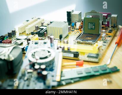 Selective focus computer chip on socket. Chipset on electronic circuit board of PC motherboard at repair workshop. CPU chip. Electronic components. Stock Photo