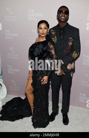 Keyshia Ka'Oir, left, wife of rapper Gucci Mane, right, pose for  photographs at courtside prior to the NBA All-Star Game at Spectrum Center  in Charlotte, N.C. on Sunday, February 17, 2019. (Photo