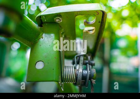 The control lever on a walk-behind tractor close-up on a blurred background. Control elements of agricultural machinery. Stock Photo