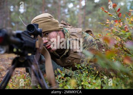 U.S. Marine Corps Pfc. Jovianni Lostal, automatic rifleman, with 1st Battalion, 8th Marine Regiment, 2d Marine Division posts security while conducting a tactical exercise during exercise Archipelago Endeavor 22 (AE22), at Berga Naval Base, Sweden, Sept. 20, 2022. AE22 is an integrated field training exercise that increases operational capability and enhances strategic cooperation between the U.S. Marines and Swedish forces. Stock Photo