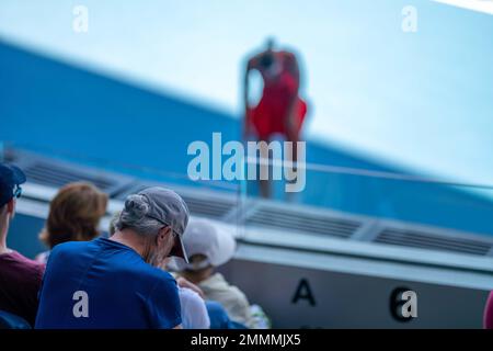 tennis fan watching a tennis match at the australian open eating food and drinking in australia Stock Photo