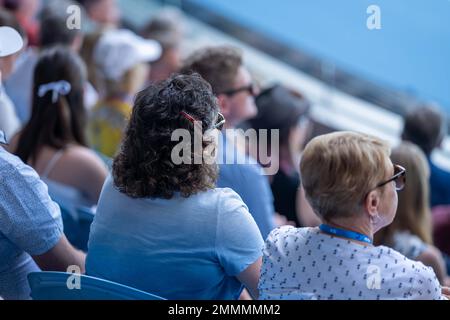 tennis fan watching a tennis match at the australian open eating food and drinking in australia Stock Photo