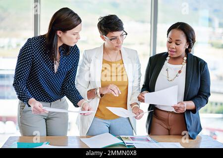 Three heads are better than one. corporate businesspeople meeting in the boardroom. Stock Photo