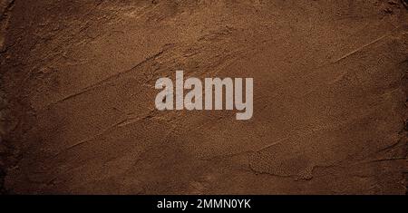 Dark chocolate brown sugar-like grainy texture background Stock Photo