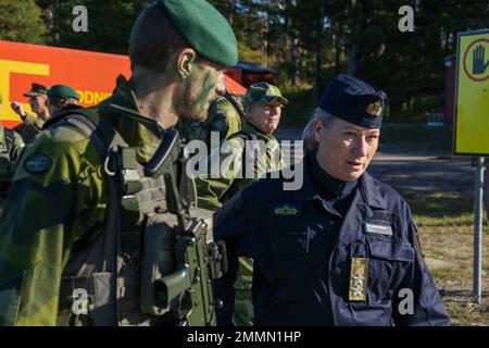 Swedish Marine Capt. Jacob Lindholm (left), Swedish ground force commander, escorts Swedish Navy Rear Admiral Ewa Skoog Haslum (right), Chief of Swedish Navy, while visiting U.S. and Swedish Marines during exercise Archipelago Endeavor 22 (AE22) on Berga Naval Base, Sweden, Sept. 21, 2022. AE22 is an integrated field training exercise that increases operational capability and enhances strategic cooperation between the U.S. Marines and Swedish forces. Stock Photo