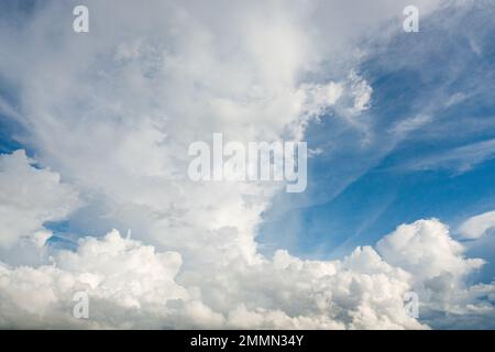 White, fluffy clouds in blue sky. Background from clouds. Stock Photo