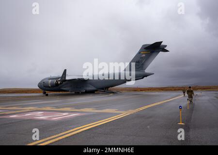 An Alaska Air National Guard C-17 Globemaster III assigned to the 176th Airlift Wing at Joint Base Elmendorf-Richardson, Alaska delivers cargo to Nome Airport, Alaska, Sept. 21, 2022. Approximately 100 members of the AKOM, which includes members of the Alaska National Guard, Alaska State Defense Force and Alaska Naval Militia, were activated following a disaster declaration issued Sept. 17 after the remnants of Typhoon Merbok caused dramatic flooding across more than 1,000 miles of Alaskan coastline. Stock Photo
