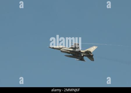 NAKHON PATHOM, THAILAND - January 14, 2023 : stunt flying, the performance of aerial feats requiring great skill or daring, Military F16 fighter jet Stock Photo