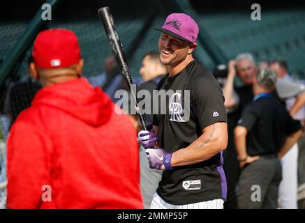 Colorado Rockies' Matt Holliday, right, gets a high-five from teammate  Jorge Piedra after scoring a run on a hit by Brad Hawpe off Los Angeles  Angels pitcher John Lackey in the sixth