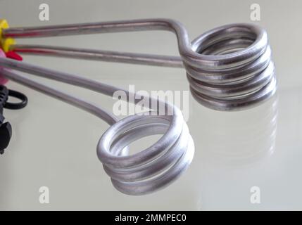 Immersion heater with a shadow on a light background. Stock Photo