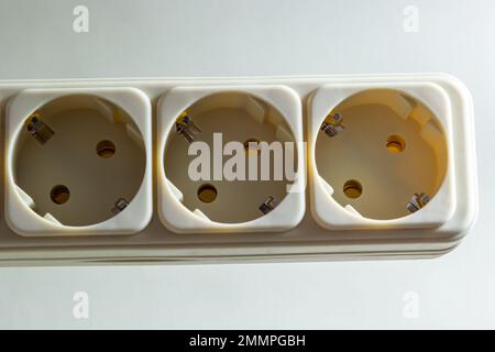 Close up of extension power strip isolated on white. Stock Photo