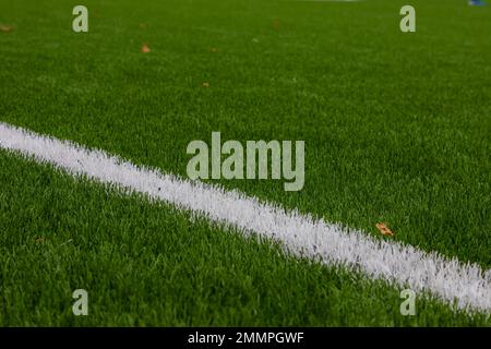 Green Synthetic Grass Sports Field with White Line Stock Photo