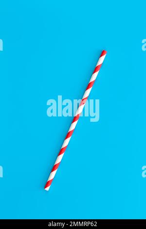 Close up of drinking straw for party on blue background, flat lay. Stock Photo