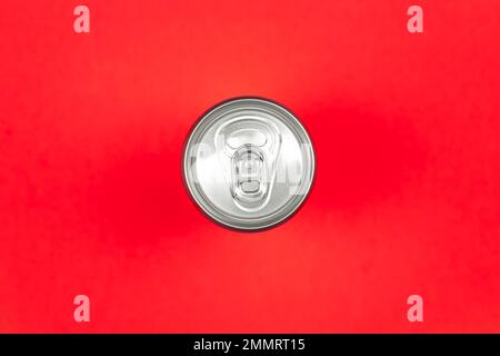 Aluminum drink or beverage can with pull ring on a red background, flat lay. Stock Photo