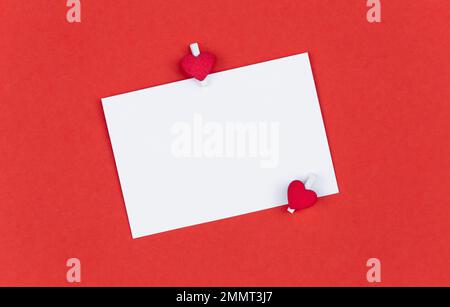Background for Valentine's Day with a sheet of paper, flat lay. Stock Photo