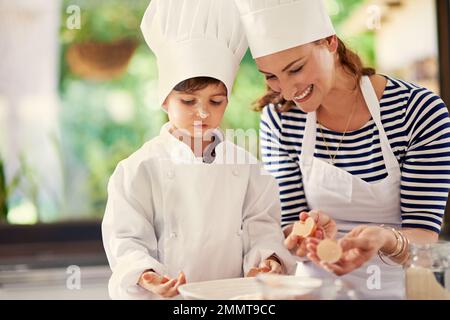 The beginning of something delicious. a mother and her son baking in the kitchen. Stock Photo