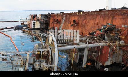 Close up sunken drowned oil tanker ship in Odessa after the wreck. Overturned oil tanker lying on its edge on the shallow water. Stock Photo