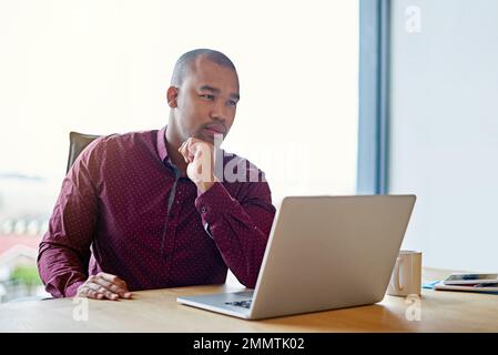 Imagination will get you everywhere. a businessman working on his laptop at his desk. Stock Photo