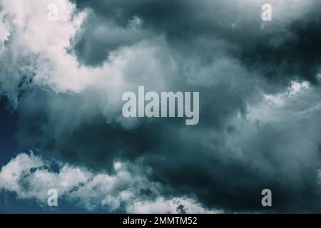 Storm clouds. Dark Blue Cloudy Rainy Sky With Rain Heavy Clouds. Storm, Thunder, Thunderstorm. Sky Natural Background. Cumulonimbus Cloud. Strange Stock Photo