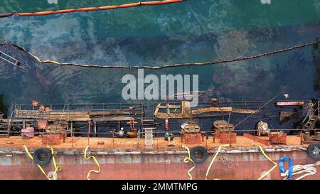 Oil tanker ran aground. Severe oil pollution of the sea. Ecological disaster. Stock Photo