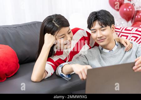 Young couples using laptop at home Stock Photo