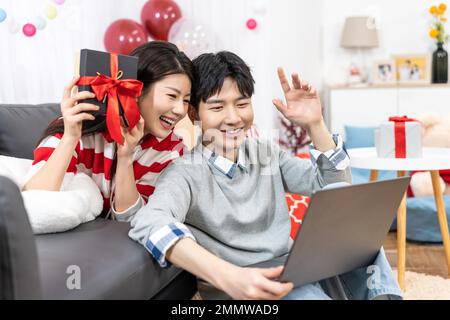 Young couples using laptop at home Stock Photo
