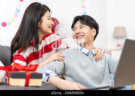 Young couples using laptop at home Stock Photo