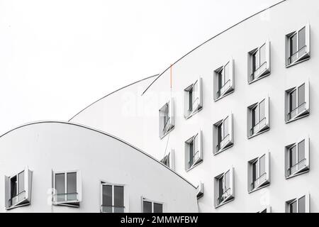 House C of the Gehry building ensemble in Düsseldorf's Media Harbour by Frank Owen Gehry. It has a nested building volume with large-format curves. Stock Photo