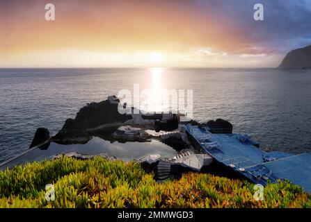 Ocean dramatic sunset over Doca do Cavacas, natural pools in Madeira. Portugal Stock Photo