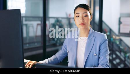 Watch, deadline and computer with a business asian woman working late at night in her office for overtime. Finance, accounting and dedication with a Stock Photo