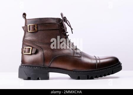 Side view of a brown colored leather boot on a white background. Stock Photo