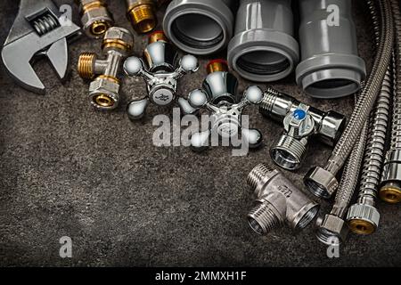 plumbers pipe fixtures fittings connectors hoses plastik pipes monkey wrench Stock Photo