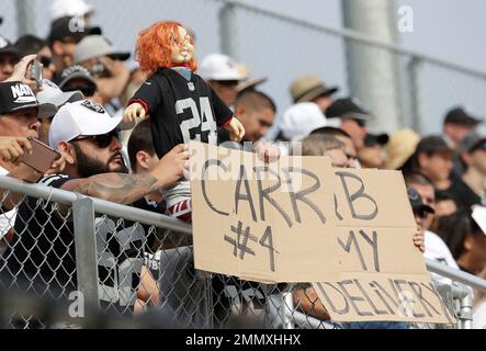 A fan holds a Chucky doll during the second half of an NFL football game  between the Oakland Raiders and the Denver Broncos in Oakland, Calif.,  Monday, Dec. 24, 2018. (AP Photo/D.