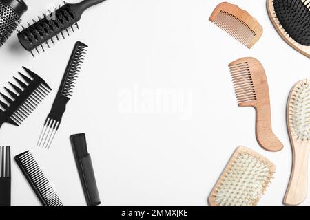 Plastic and wooden hairbrushes on white background, top view. Recycling concept Stock Photo