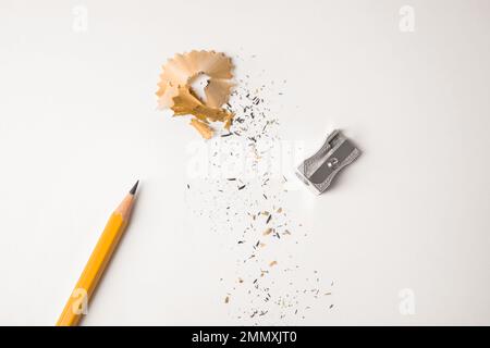 Pencil, sharpener and shavings on white background, top view Stock Photo