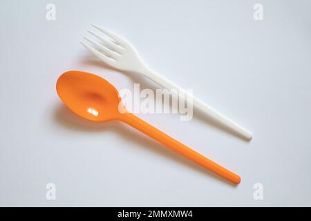 plastic disposable spoon and fork on isolated background, disposable tableware and cutlery Stock Photo