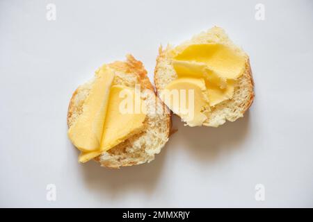 white bread with butter on a white background, a slice of bread and butter on an isolated background Stock Photo