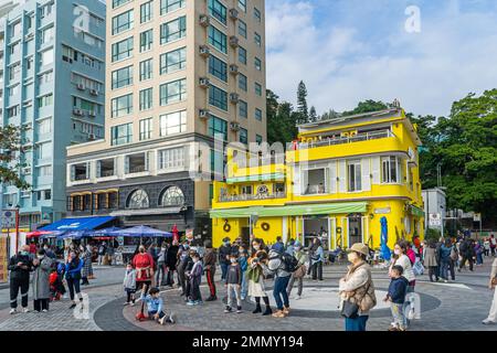 Stanley village, Hong Kong - Street scene, man playing guitar  on the main promenade road Stock Photo