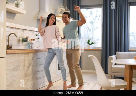 Lovely young interracial couple dancing at home Stock Photo
