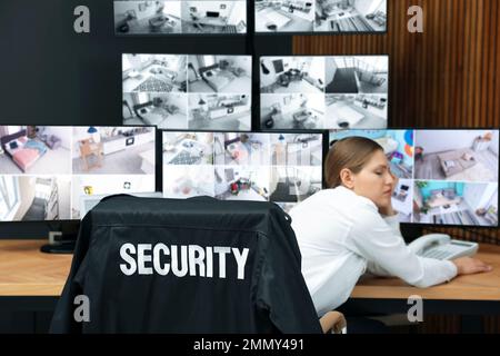 Tired security guard sleeping at workplace in office Stock Photo