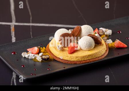 Sliced No Bake Strawberry Cheesecake Decorated with Strawberry, black background Stock Photo