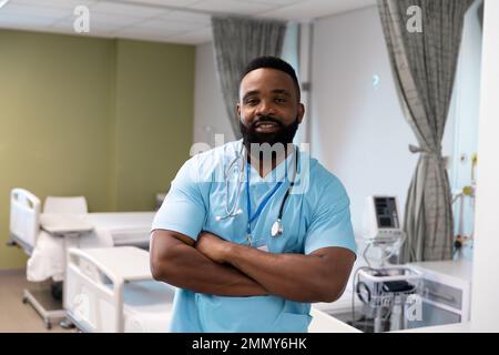 Portrait of happy african american male doctor working at hospital Stock Photo