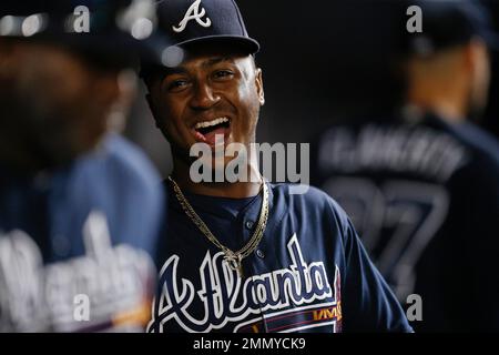 Ozzie Albies of the Atlanta Braves laughs in the dugout during the