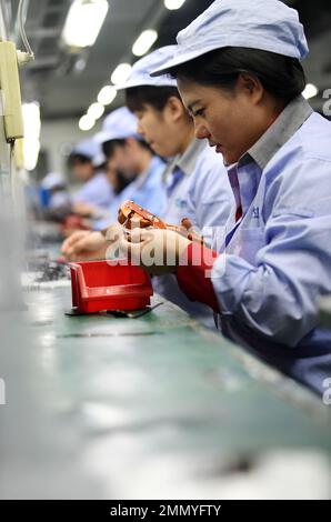 ZHANGJIAKOU, CHINA - JANUARY 30, 2023 - Workers work on an assembly line at Bluebird Fire Protection Co LTD in Zhuolu Economic Development Zone, North Stock Photo