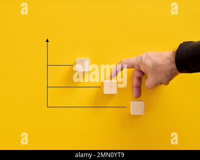 Business growth, success and development. Career improvement. Ladder of success. Male fingers walking up towards the ladder of wooden blocks. Stock Photo